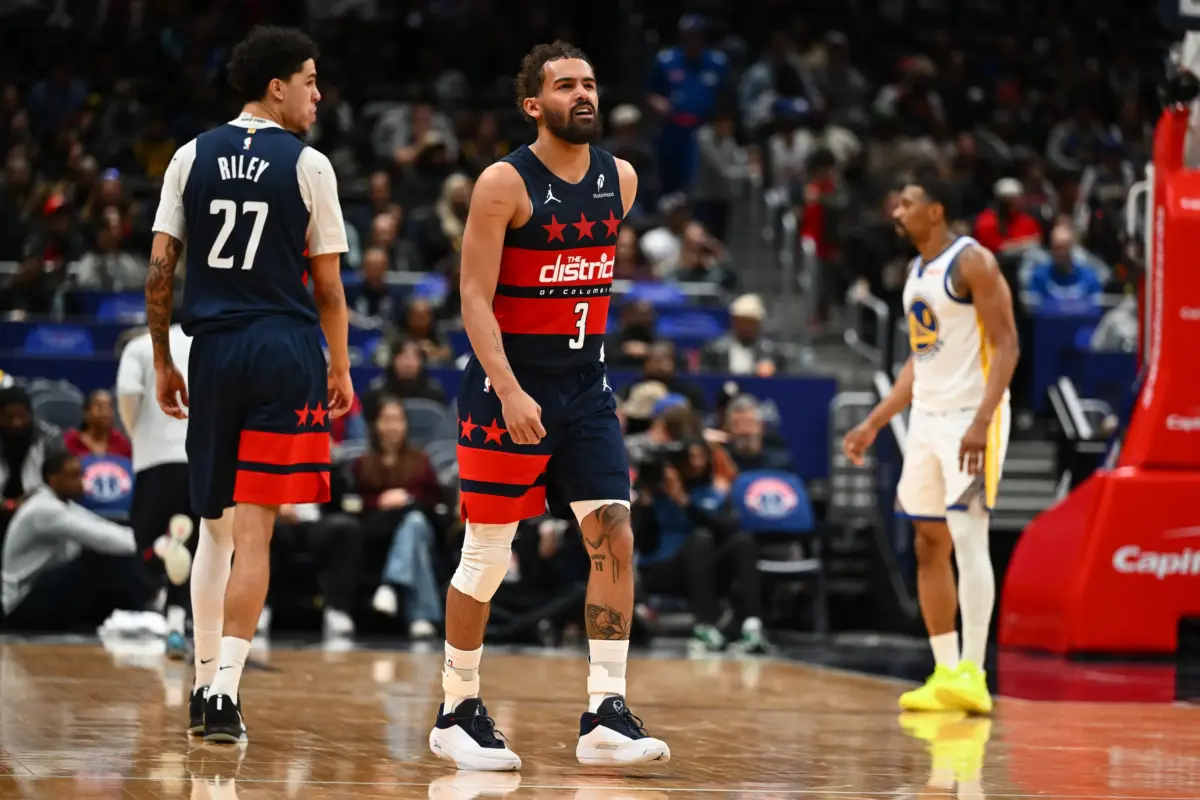 Mar 16, 2026; Washington, District of Columbia, USA; Washington Wizards guard Trae Young (3) reacts after suffering an apparent injury against the Golden State Warriors during the second half at Capital One Arena. Mandatory Credit: Brad Mills-Imagn Images