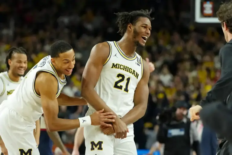 Apr 6, 2026; Indianapolis, IN, USA; Michigan Wolverines forward Morez Johnson Jr. (21) and guard Nimari Burnett (4) celebrate after their win against the UConn Huskies in the national championship of the Final Four of the men's 2026 NCAA Tournament between the and the Michigan Wolverines at Lucas Oil Stadium. Mandatory Credit: Bob Donnan-Imagn Images