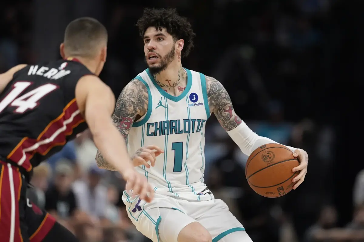 Apr 14, 2026; Charlotte, North Carolina, USA; Charlotte Hornets guard LaMelo Ball (1) looks to pass defended by Miami Heat guard Tyler Herro (14) during the second half during the play-in rounds between the Charlotte Hornets and the Miami Heat of the 2026 NBA Playoffs at Spectrum Center. Mandatory Credit: Jim Dedmon-Imagn Images. They will have picks 14 and 18 in the 2026 NBA Draft.