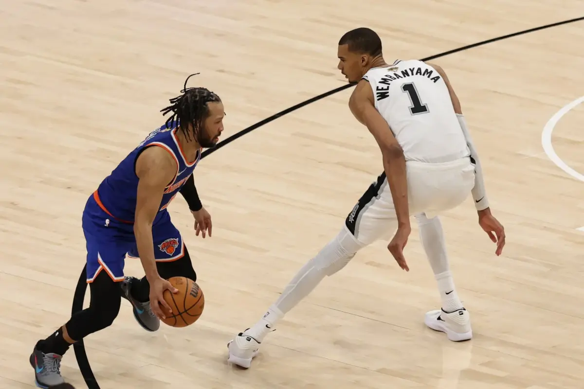 Jun 5, 2026; San Antonio, Texas, USA; New York Knicks guard Jalen Brunson (11) dribbles the ball against San Antonio Spurs forward Victor Wembanyama (1) in the second half during game two of the 2026 NBA Finals at Frost Bank Center. Mandatory Credit: Geoff Burke-Imagn Images. The Spurs vs Knicks series heads back to New York in a pivotal Game 3.