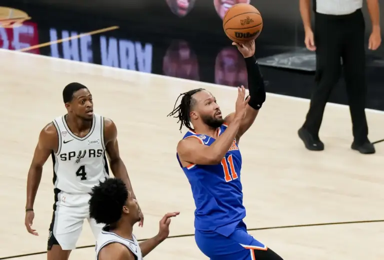 Jun 13, 2026; San Antonio, Texas, USA; New York Knicks guard Jalen Brunson (11) shoots past San Antonio Spurs guard De'aaron Fox (4) in the first half during game five of the 2026 NBA Finals at Frost Bank Center. Mandatory Credit: Scott Wachter-Imagn Images