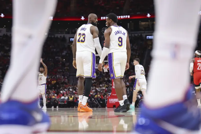 Apr 26, 2026; Houston, Texas, USA; Los Angeles Lakers forward LeBron James (23) and guard Bronny James (9) walk on the court during the third quarter against the Houston Rockets during game four of the first round of the 2026 NBA Playoffs at Toyota Center. Mandatory Credit: Troy Taormina-Imagn Images