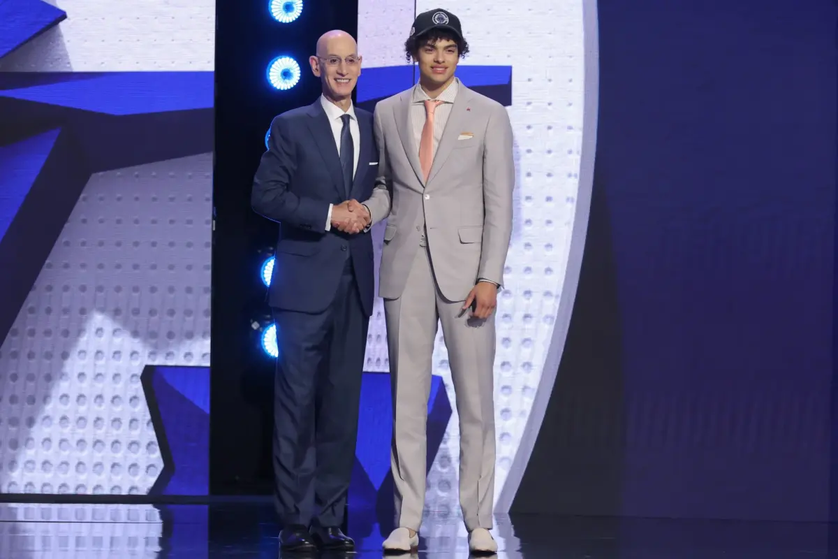 Jun 23, 2026; New York, NY, USA; NBA commissioner Adam Silver greets the fifth pick in the 2026 NBA draft, Illinois guard Keaton Wagler after he was selected by the Los Angeles Clippers at Barclays Center. Mandatory Credit: Brad Penner-Imagn Images. Wagler highlights the Clippers' Summer League team.