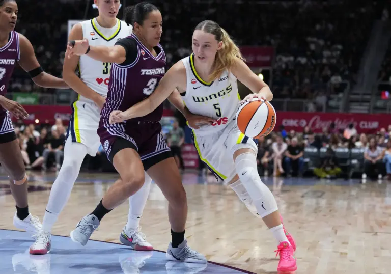 Jul 5, 2026; Toronto, Ontario, CAN; Dallas Wings guard Paige Bueckers (5) controls the ball as Toronto Tempo guard Tima Pouye (32) tries to defend during the second quarter at Coca-Cola Coliseum. Mandatory Credit: Nick Turchiaro-Imagn Images. Bueckers will look to have an great performance in the upcoming Wings vs Liberty game.