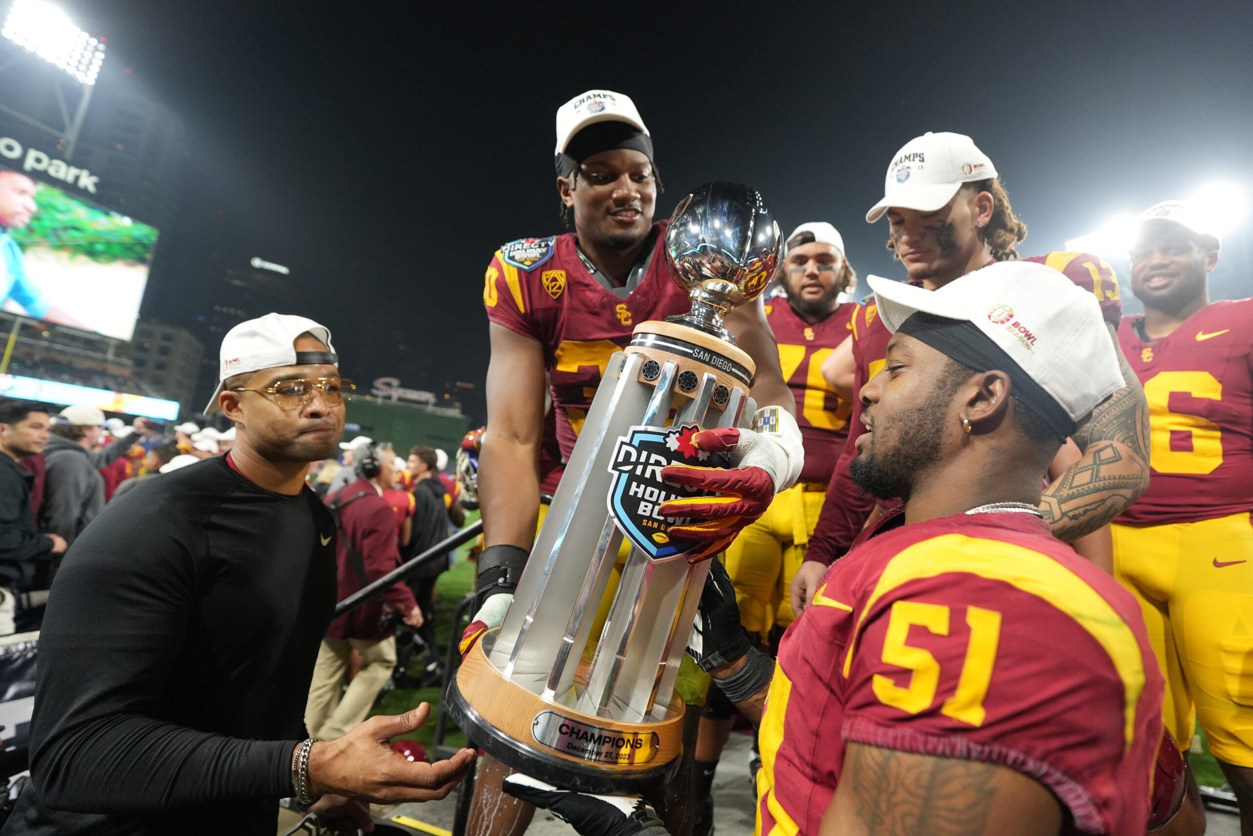 USC defeated Louisville 42-28 in the Holiday Bowl. Read about the Trojans' quarterback Miller Moss' record-breaking performance.