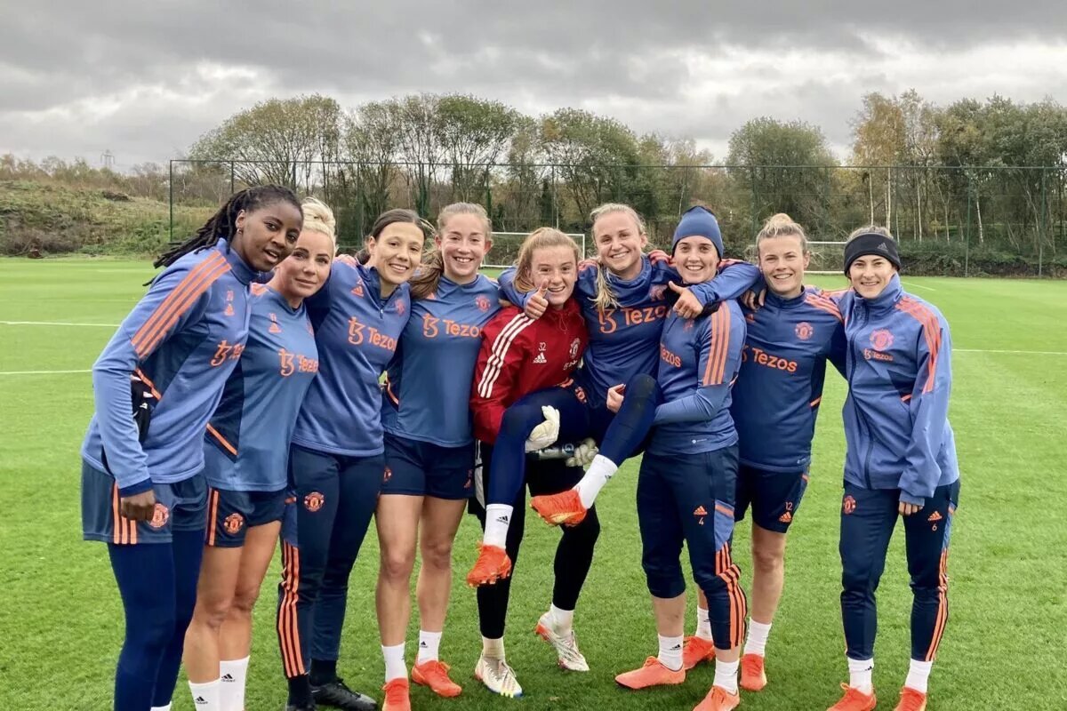 Manchester United Women players all smiles in a group following training