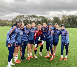 Manchester United Women players all smiles in a group following training