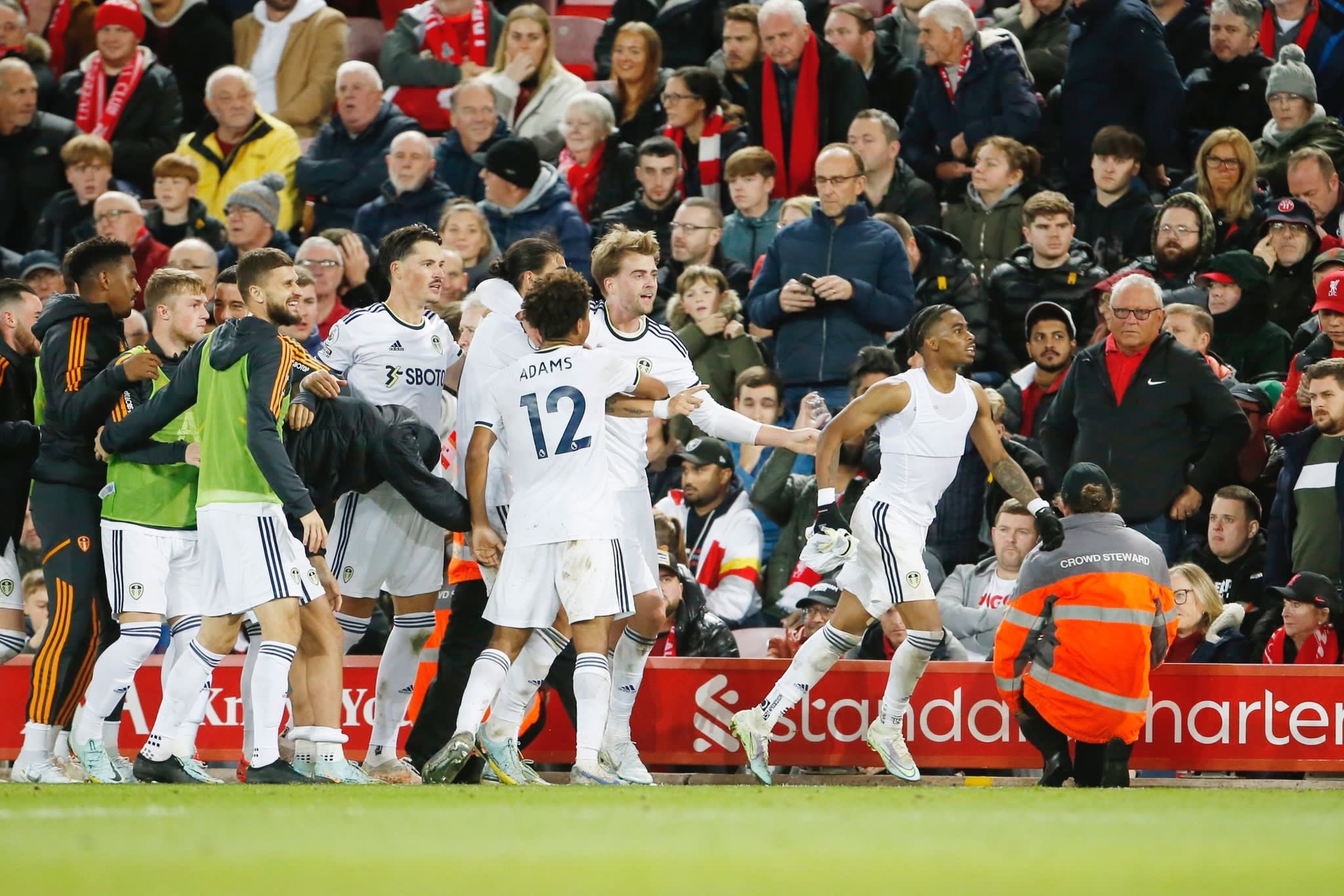 The Leeds United lineup celebrates a goal against Liverpool at Anfield