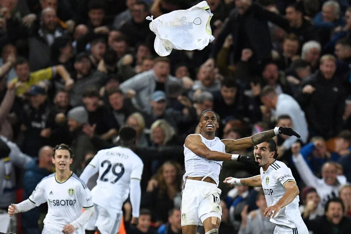 Leeds United player Crysencio Summerville celebrating by throwing his shirt.