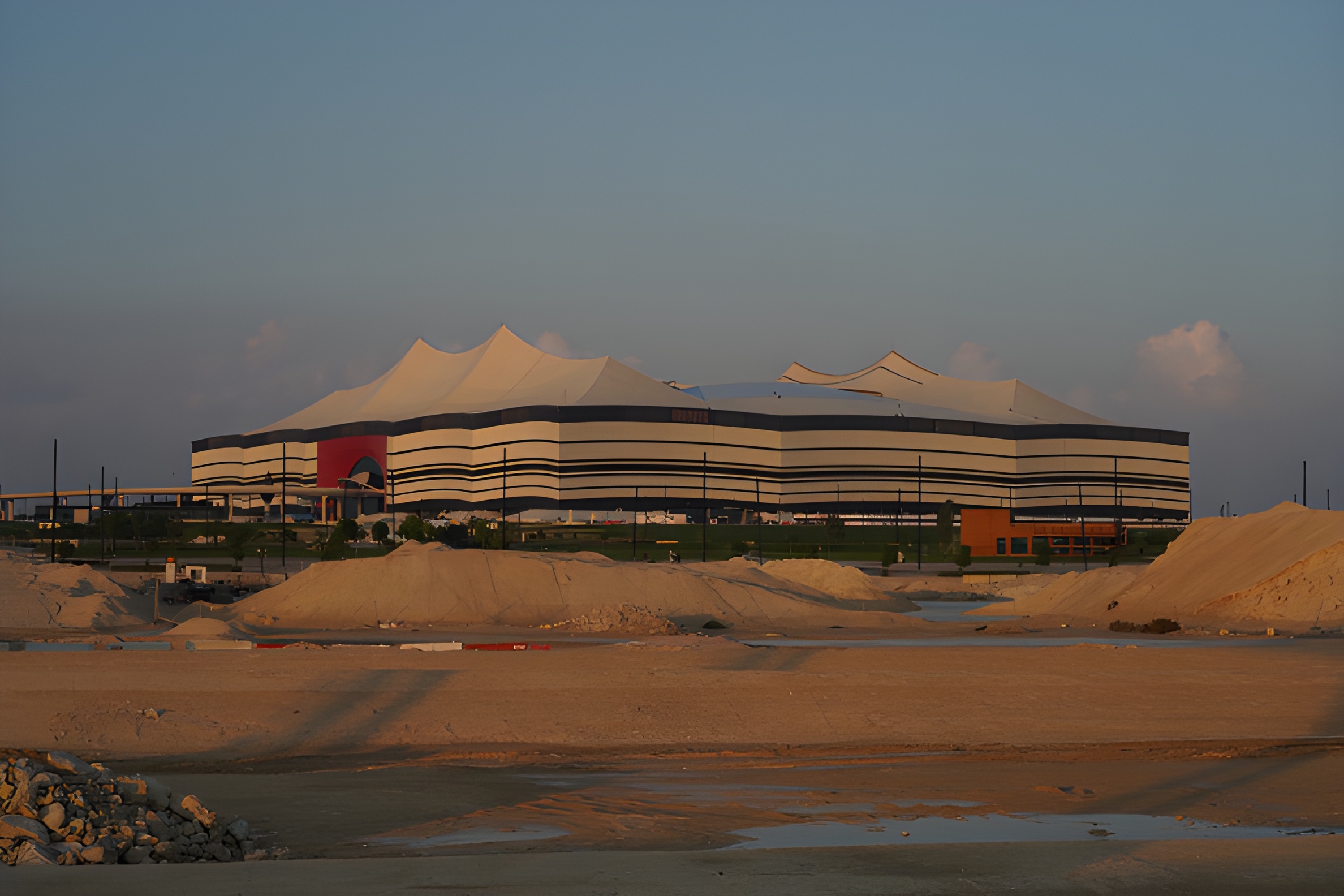 Image of a Qatari football stadium behind a construction site