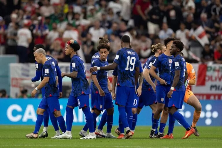 USA team in the middle of the pitch after World Cup Group B match