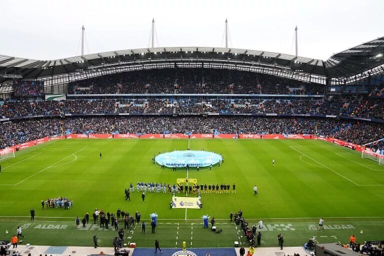 Maximo Peronne Joins Manchester City - Image of teams lining out at Etihad Stadium