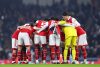 Arsenal squad huddle before a game