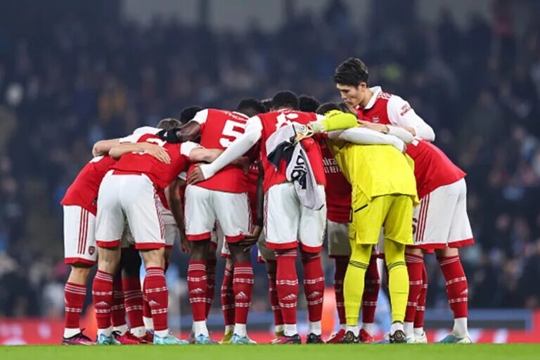 Arsenal squad huddle before a game