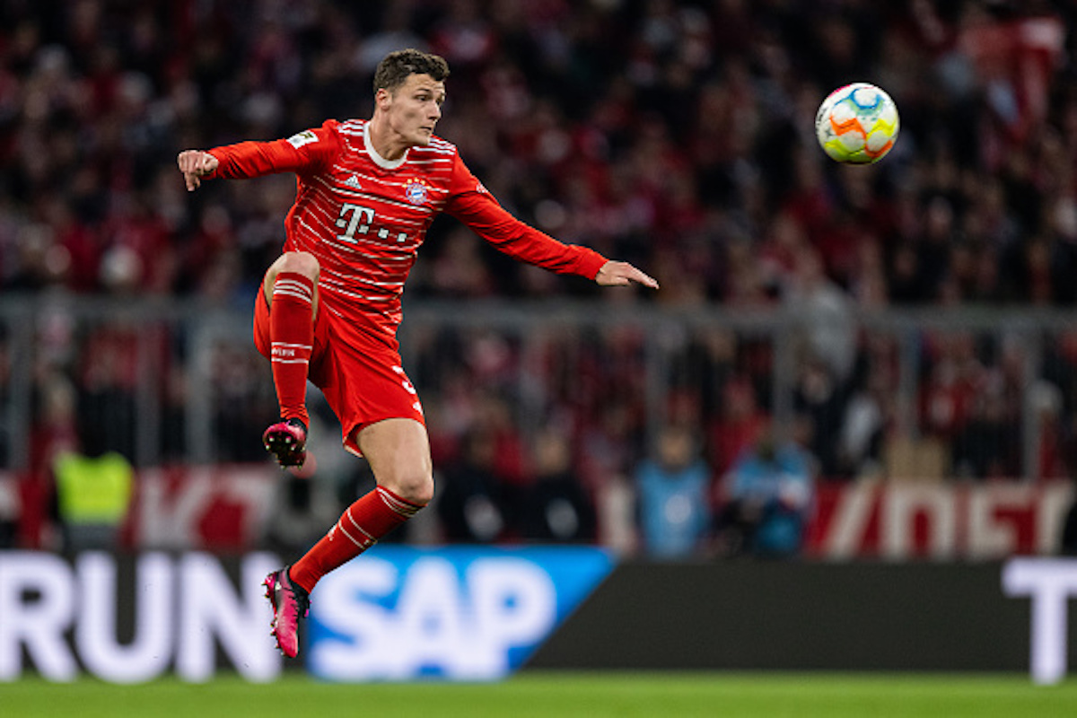 Benjamin Pavard jumps in the air to control the ball