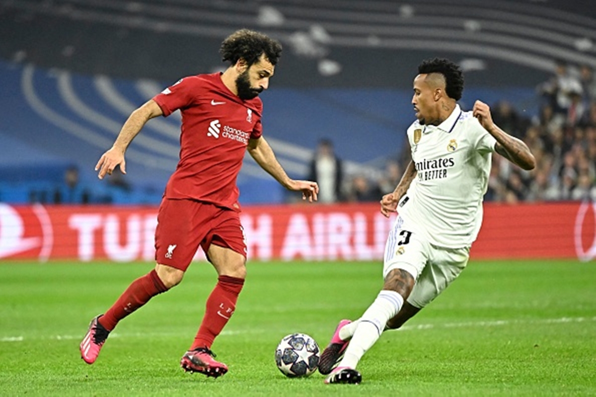 Liverpool Predicted lineup - Mo Salah attempts to take the ball past a Real Madrid defender