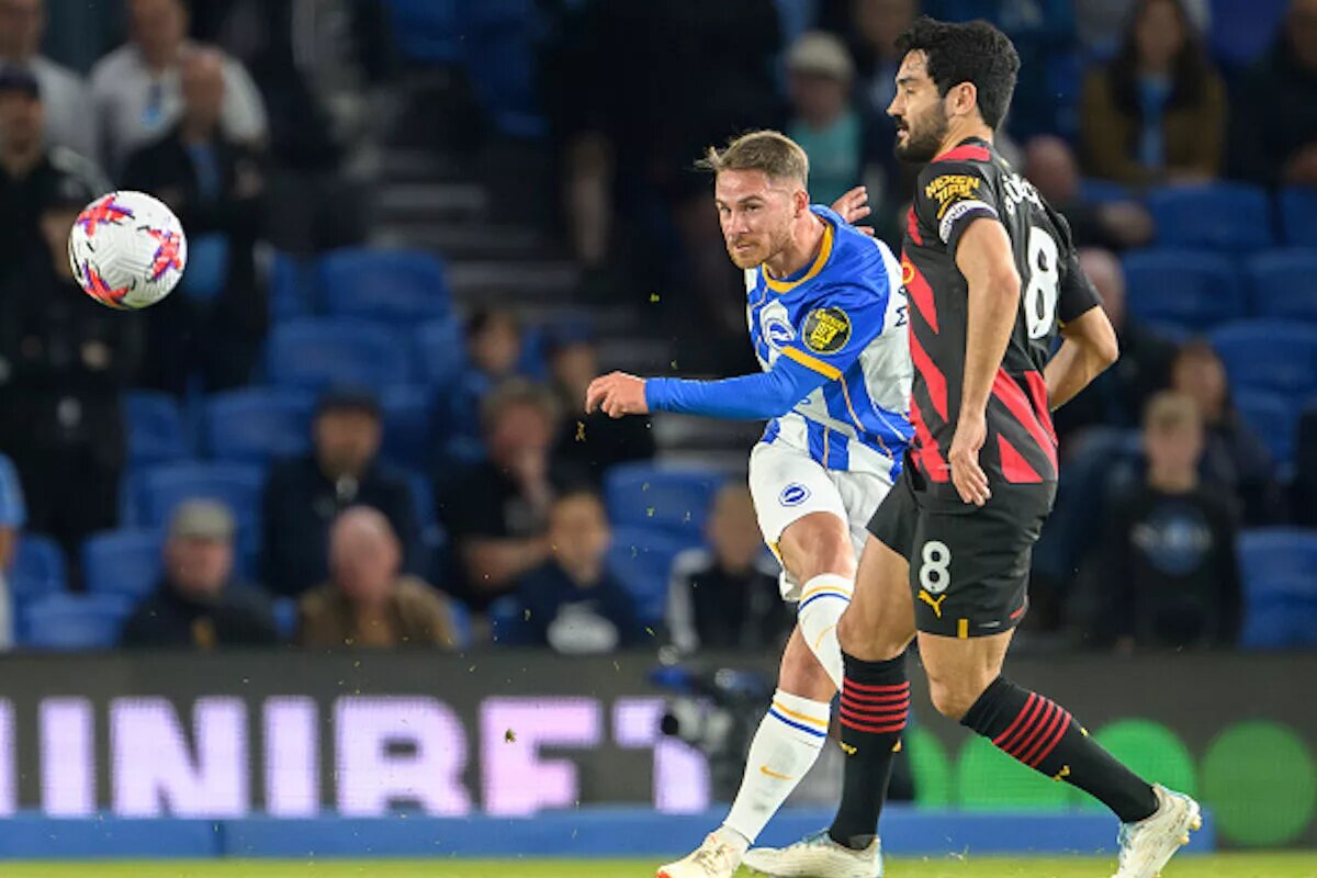 Brighton player Alexis Mac Allister taking a shot in a Premier League match vs Manchester City