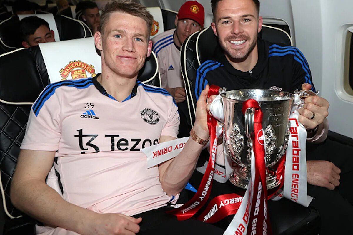 Jack Butland, whose imminent departure was cause for the latest Manchester United transfer update, holding the Carabou Cup trophy with Scott McTominay