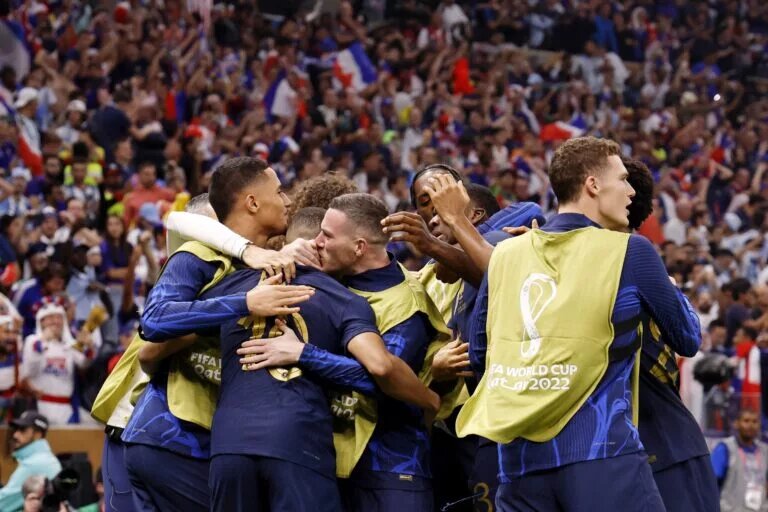 Kylian Mbappe celebrates with teammates