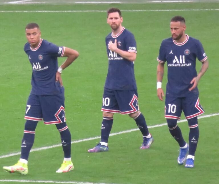 Kylian Mbappe next to teammates Lionel Messi and Neymar