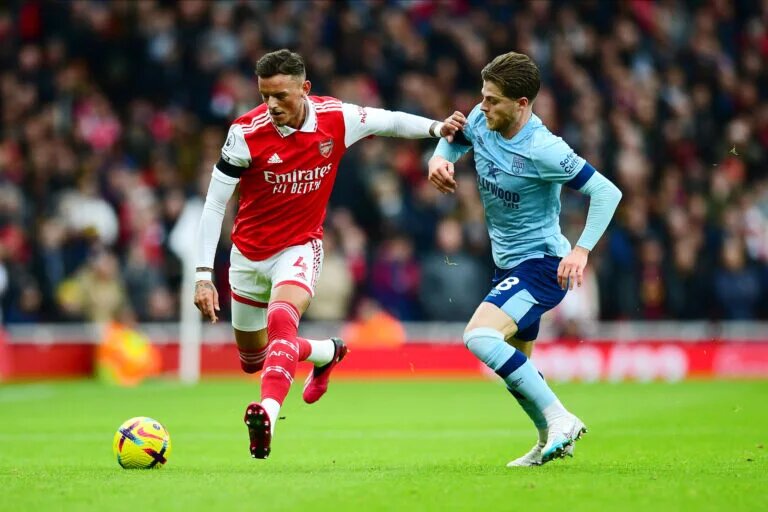 Ben White holds off a challenge from Mathias Jensen