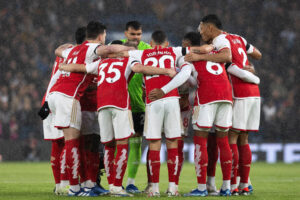 Arsenal players forming a huddle ahead of their Premier League clash against Chelsea