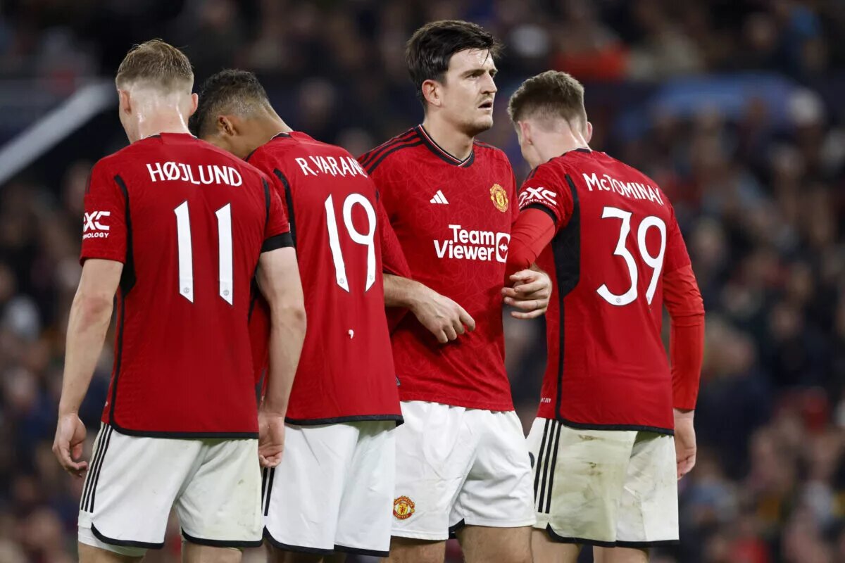 Manchester United defense forms a wall to block a free kick