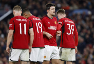 Manchester United defense forms a wall to block a free kick