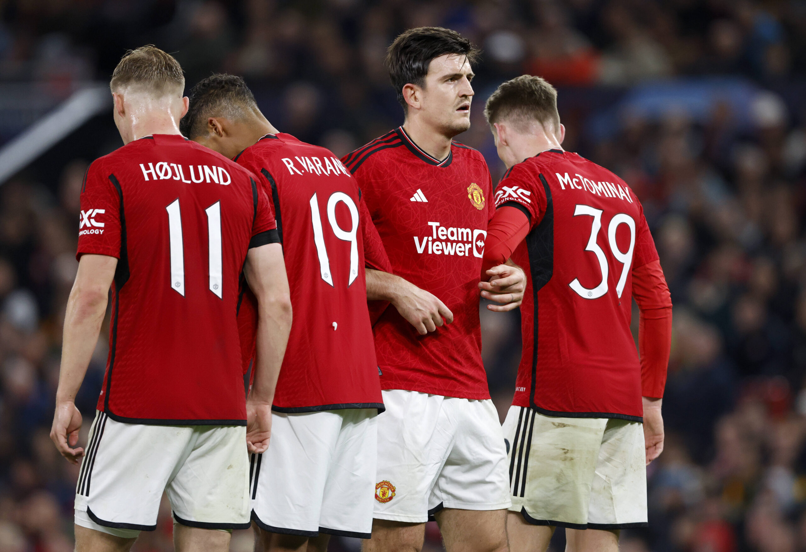 Manchester United defense forms a wall to block a free kick