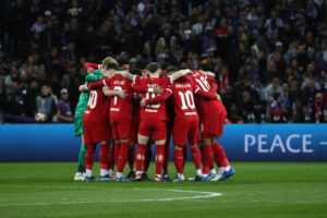 Liverpool players huddled before a match