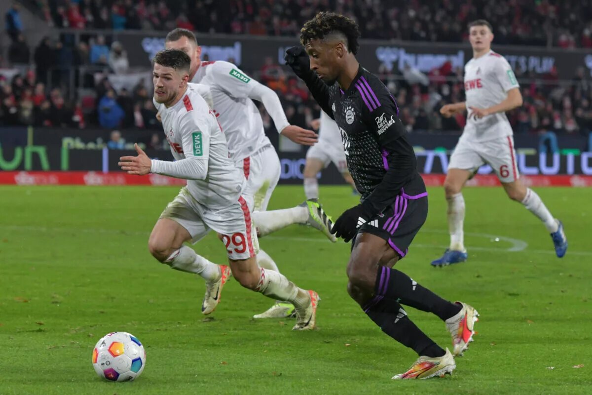 Kingsley Coman dribbles past a Koln defender