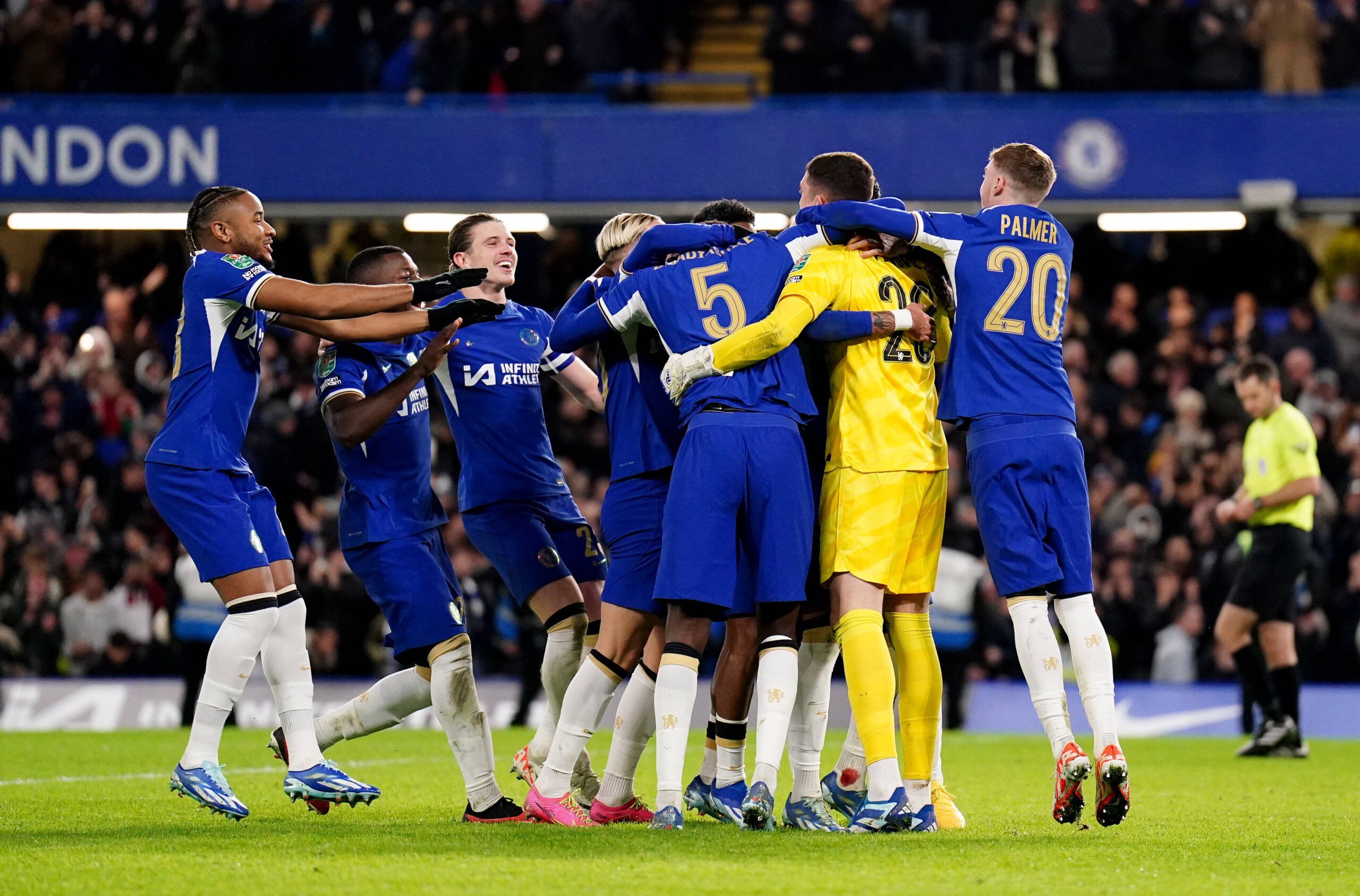 Chelsea players huddle together in celebration