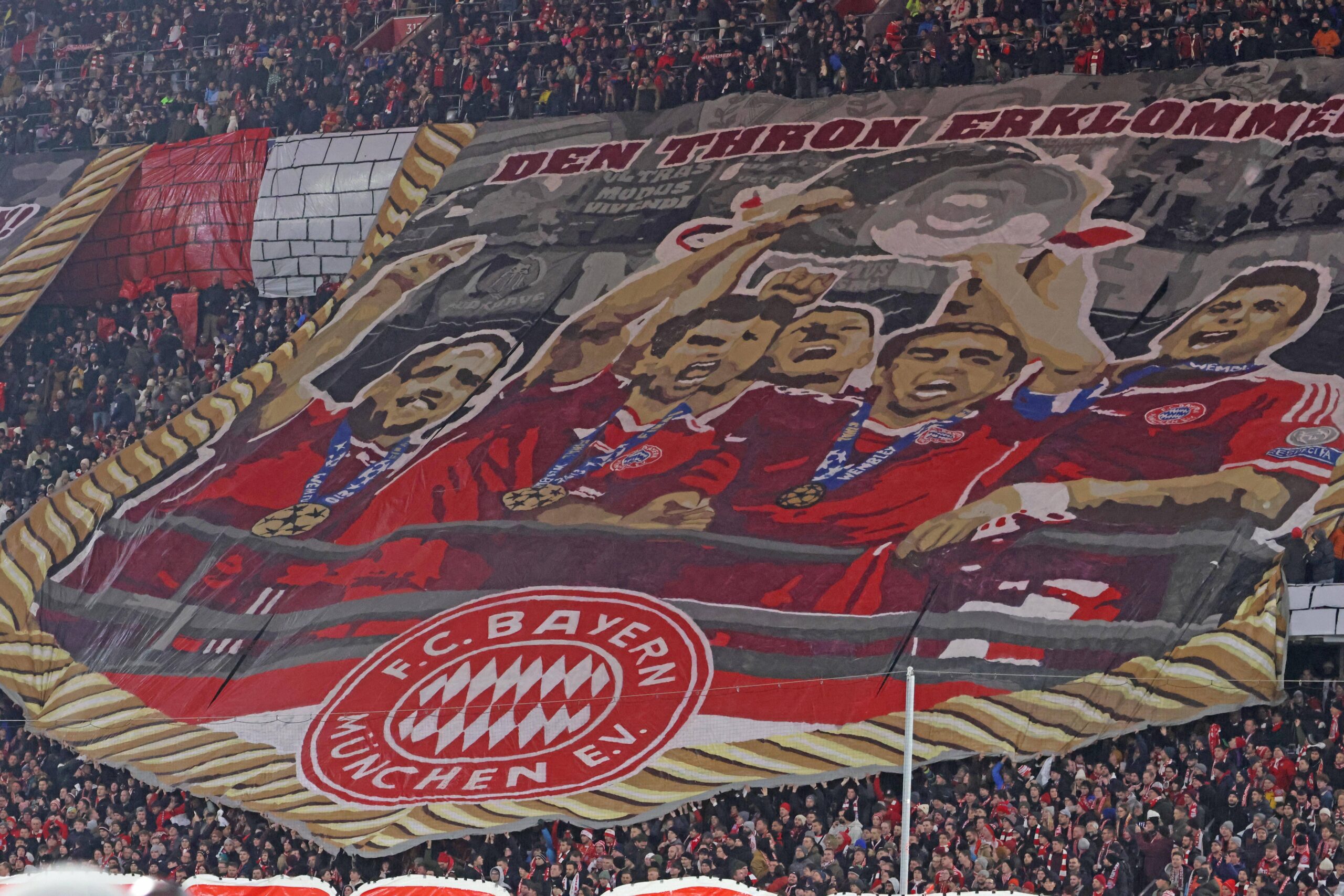 A Bayern Munich fan banner showing the heroes of the 2013 Wembley triumph