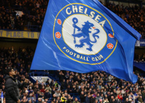 Chelsea flag being raised by fans at Stamford Bridge