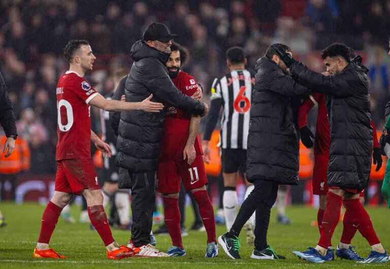Jurgen Klopp embraces players after a win