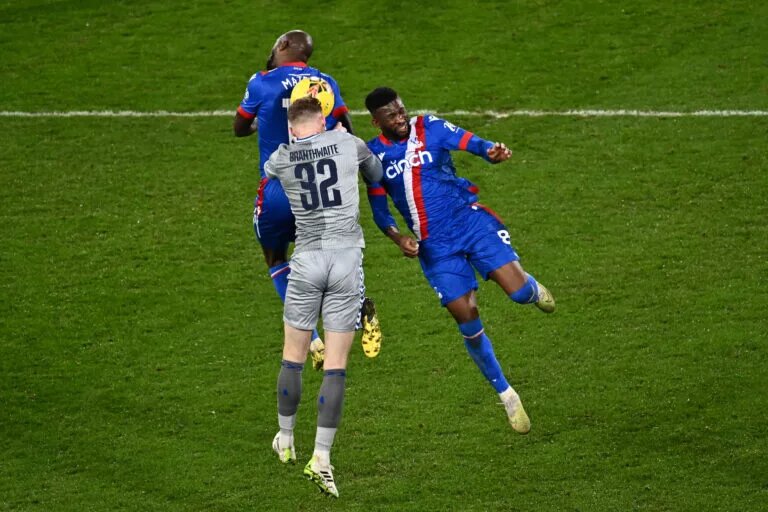 Everton's Jarrad Brantwaithe rises to head the ball against two opposition players