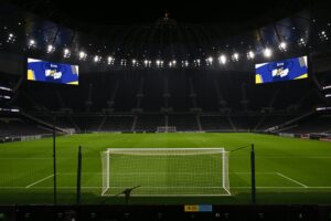Empty Tottenham Hotspur stadium displaying graphics for a cup tie