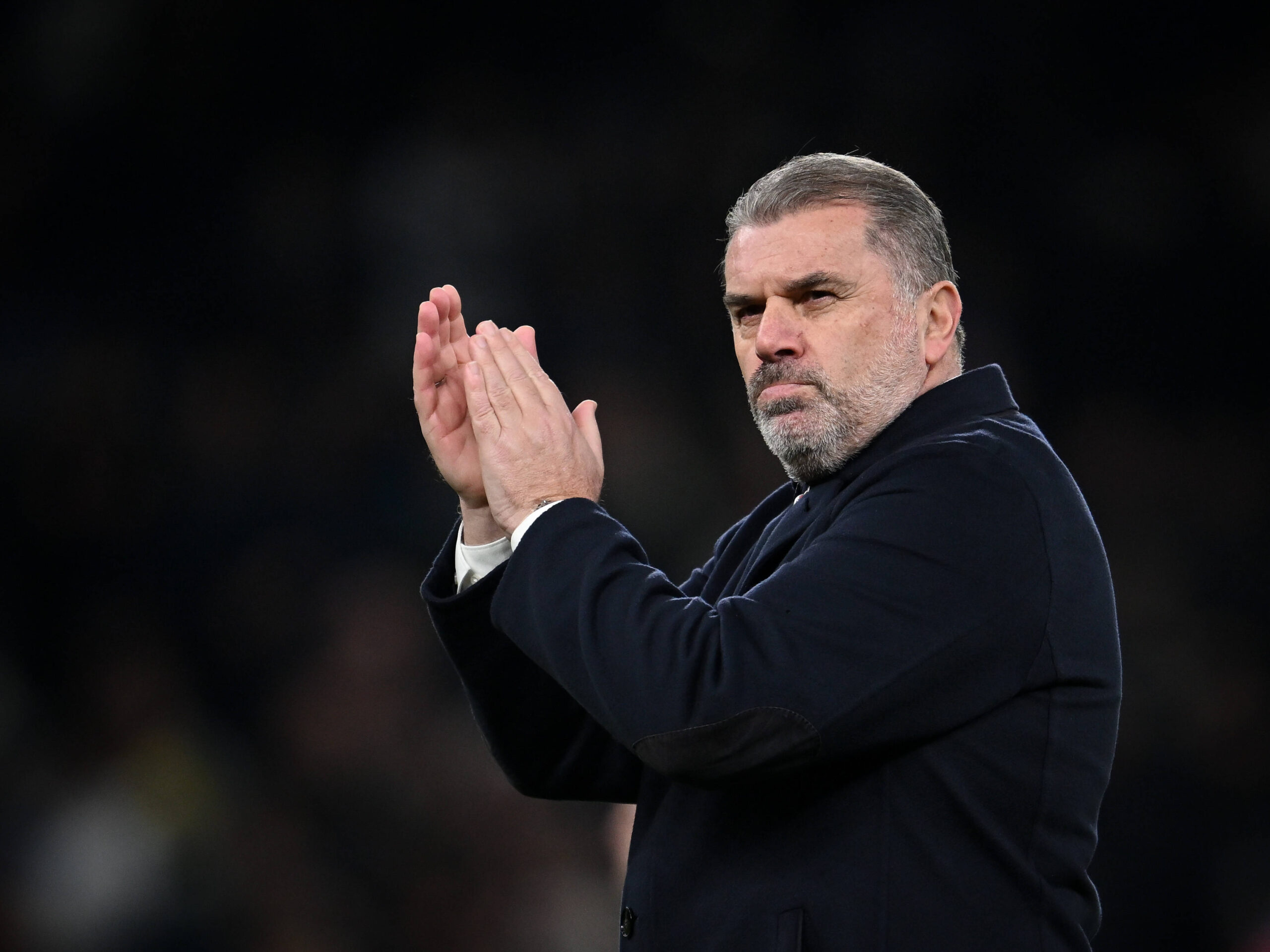 Ange Postecoglou applauding fans as he exits the pitch