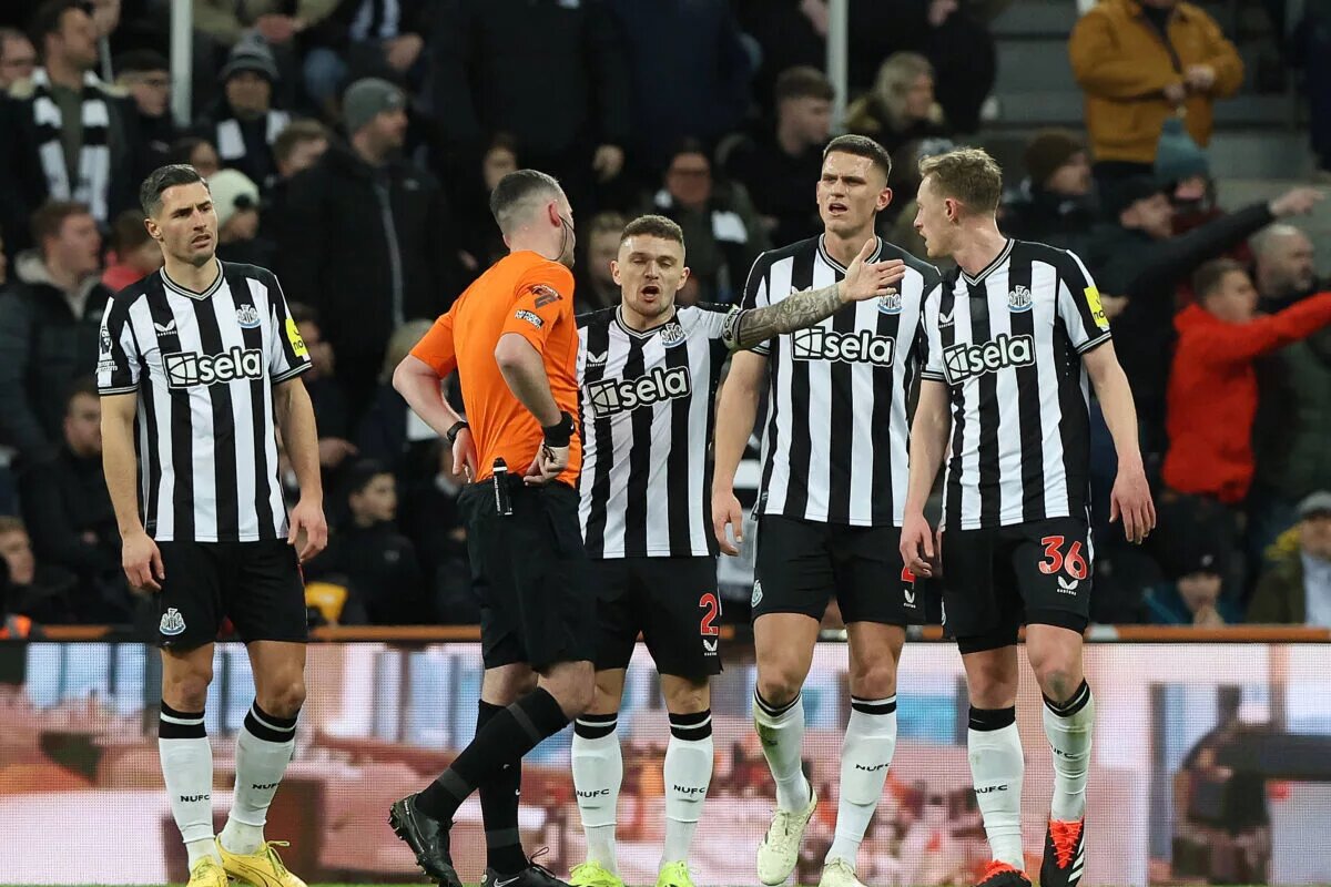 Newcastle United players talking to the referee following a decision