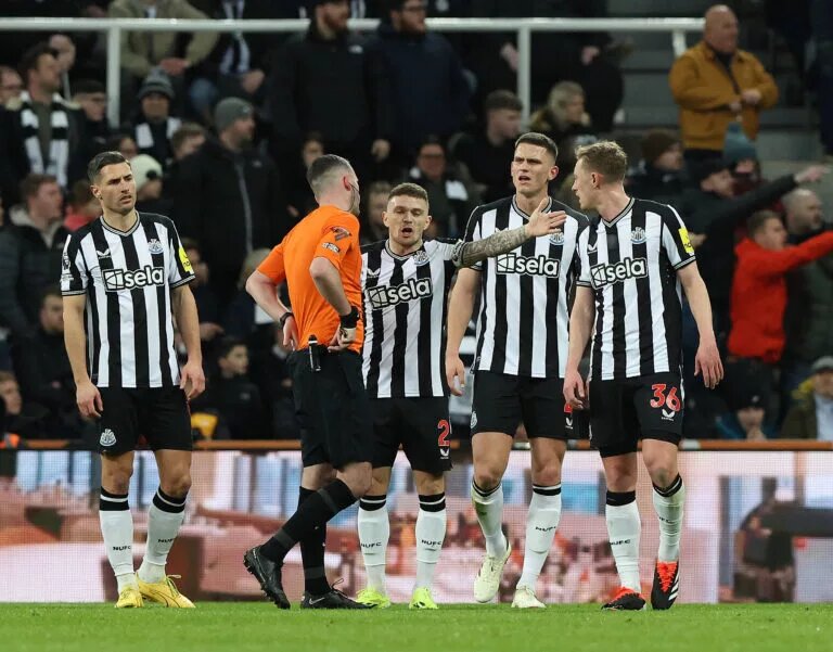 Newcastle United players talking to the referee following a decision