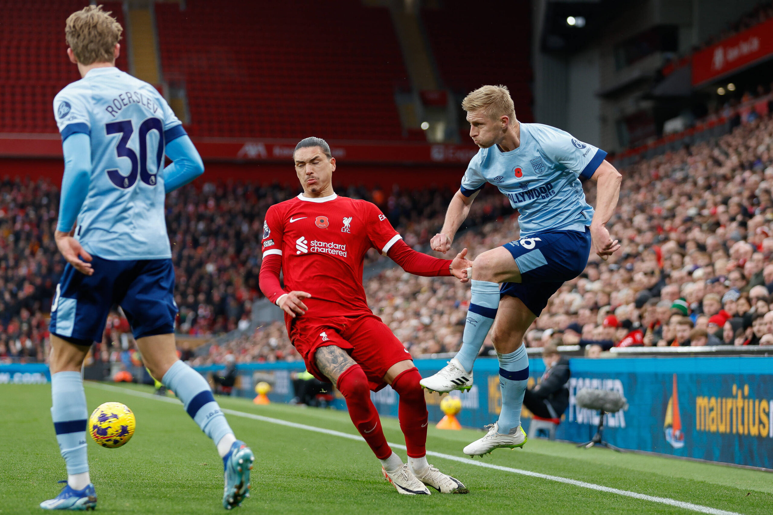 Ben Mee of Brentford clears the ball despite being closed down by Darwin Nunezs of Liverpool