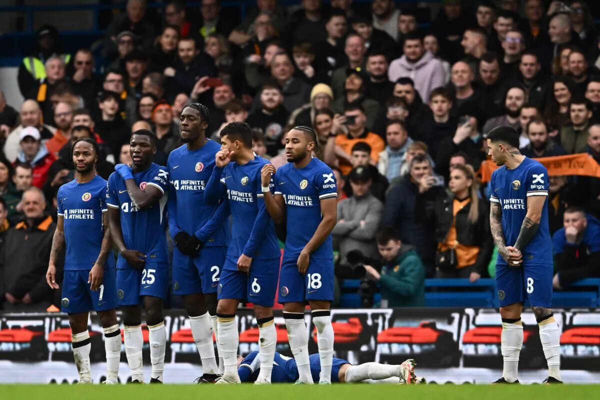 Chelsea players form a wall to stop a free kick