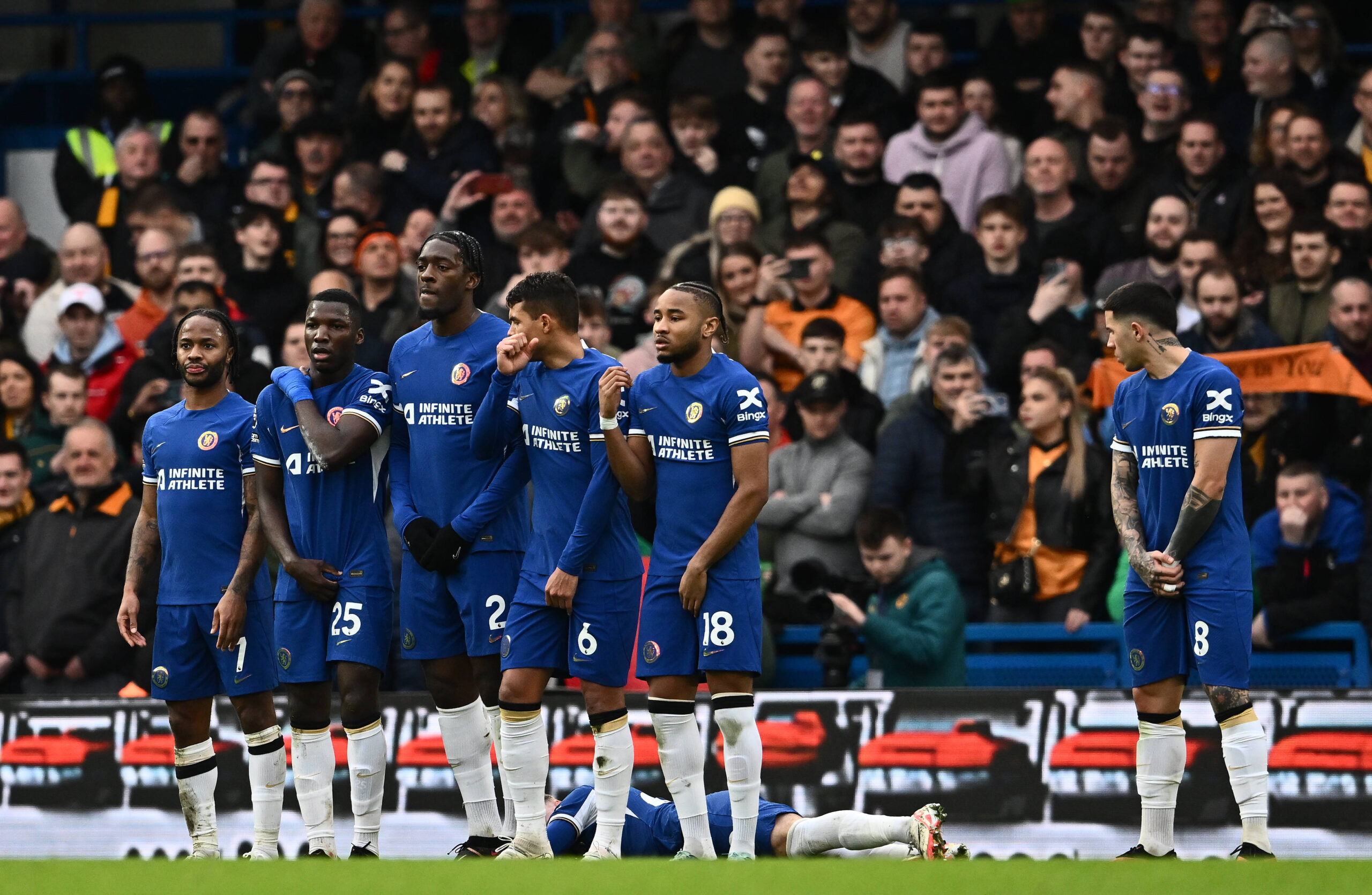 Chelsea players form a wall to stop a free kick