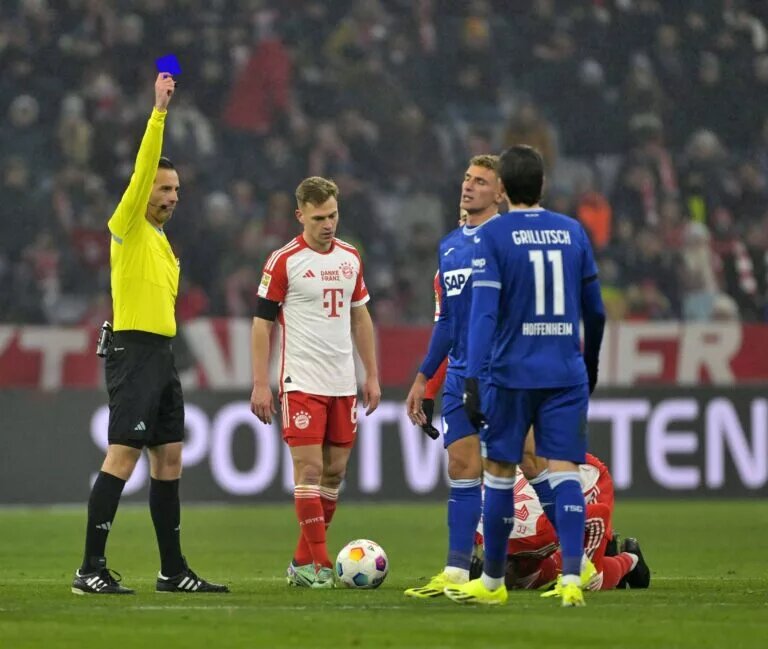 Edited image showing a refereee giving a player a blue card instead of a yellow card