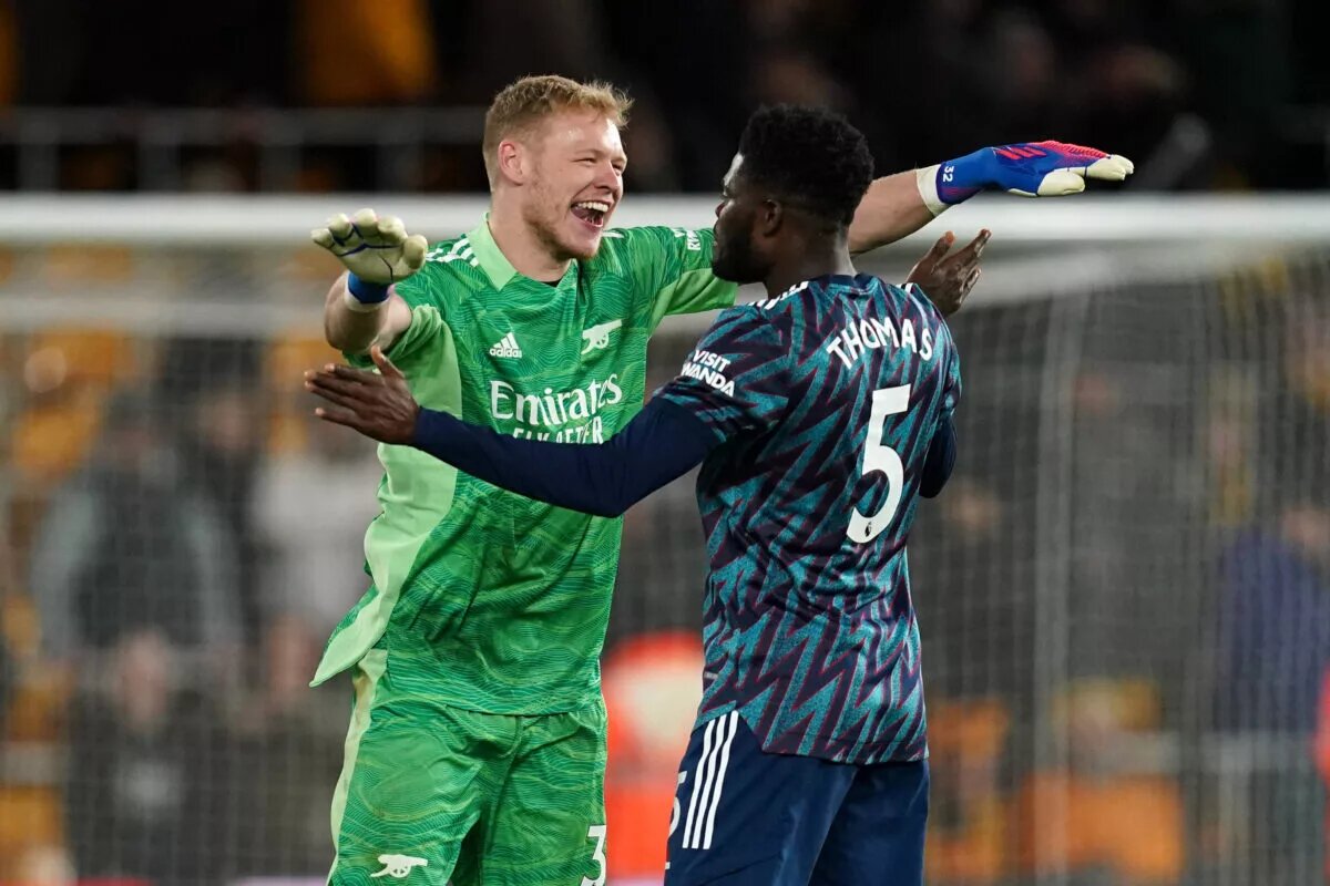 Aaron Ramsdale and Thomas Partey celebrate after winning a Premier League match against Wolves.