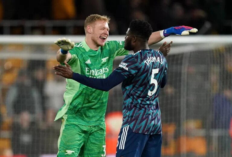 Aaron Ramsdale and Thomas Partey celebrate after winning a Premier League match against Wolves.