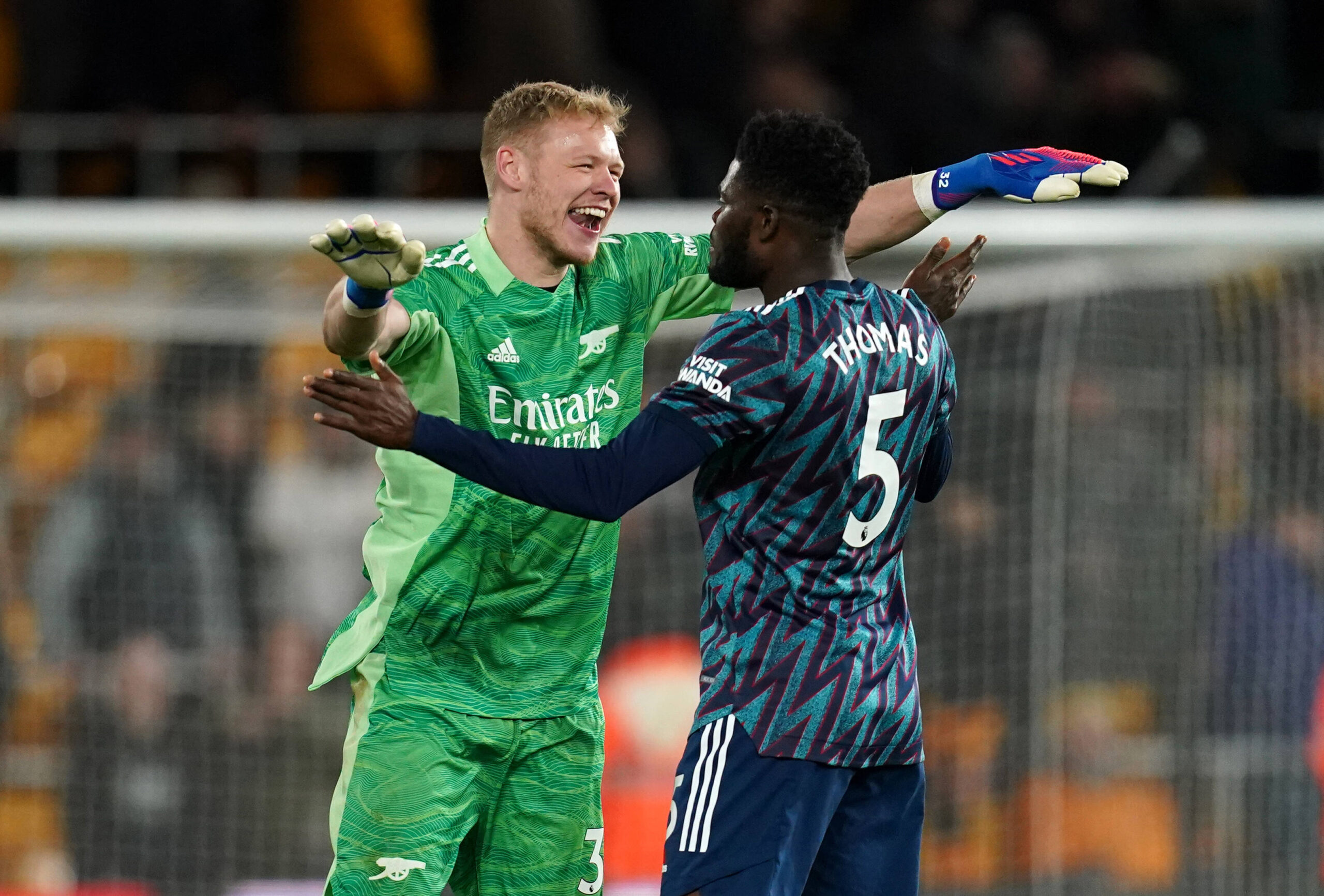 Aaron Ramsdale and Thomas Partey celebrate after winning a Premier League match against Wolves.
