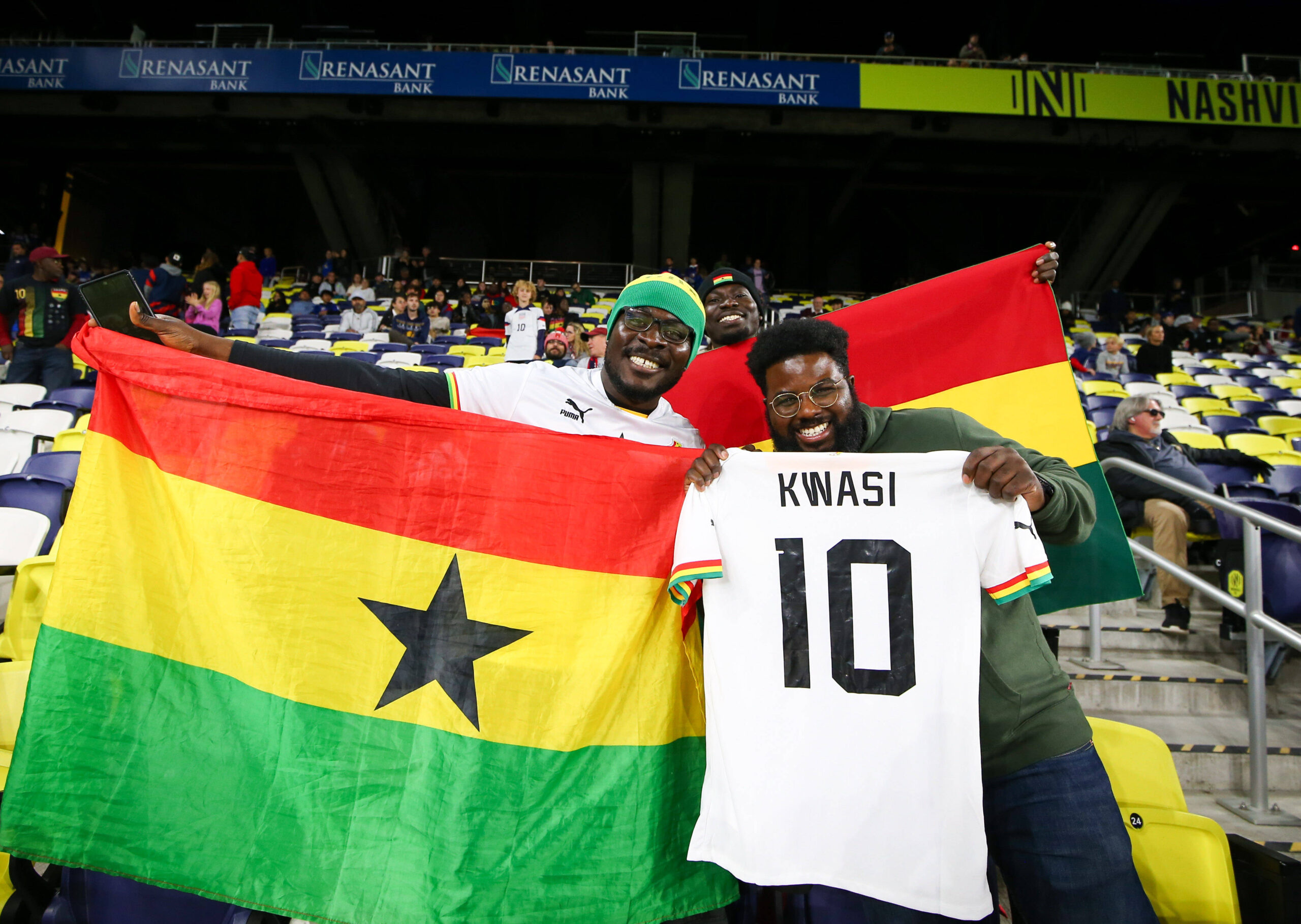 Ghana fans in the stands with a flag and player jerseys ahead of a Friendly