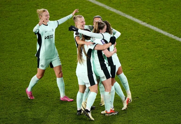 Cat Macario celebrates comeback goal with teammates embrace