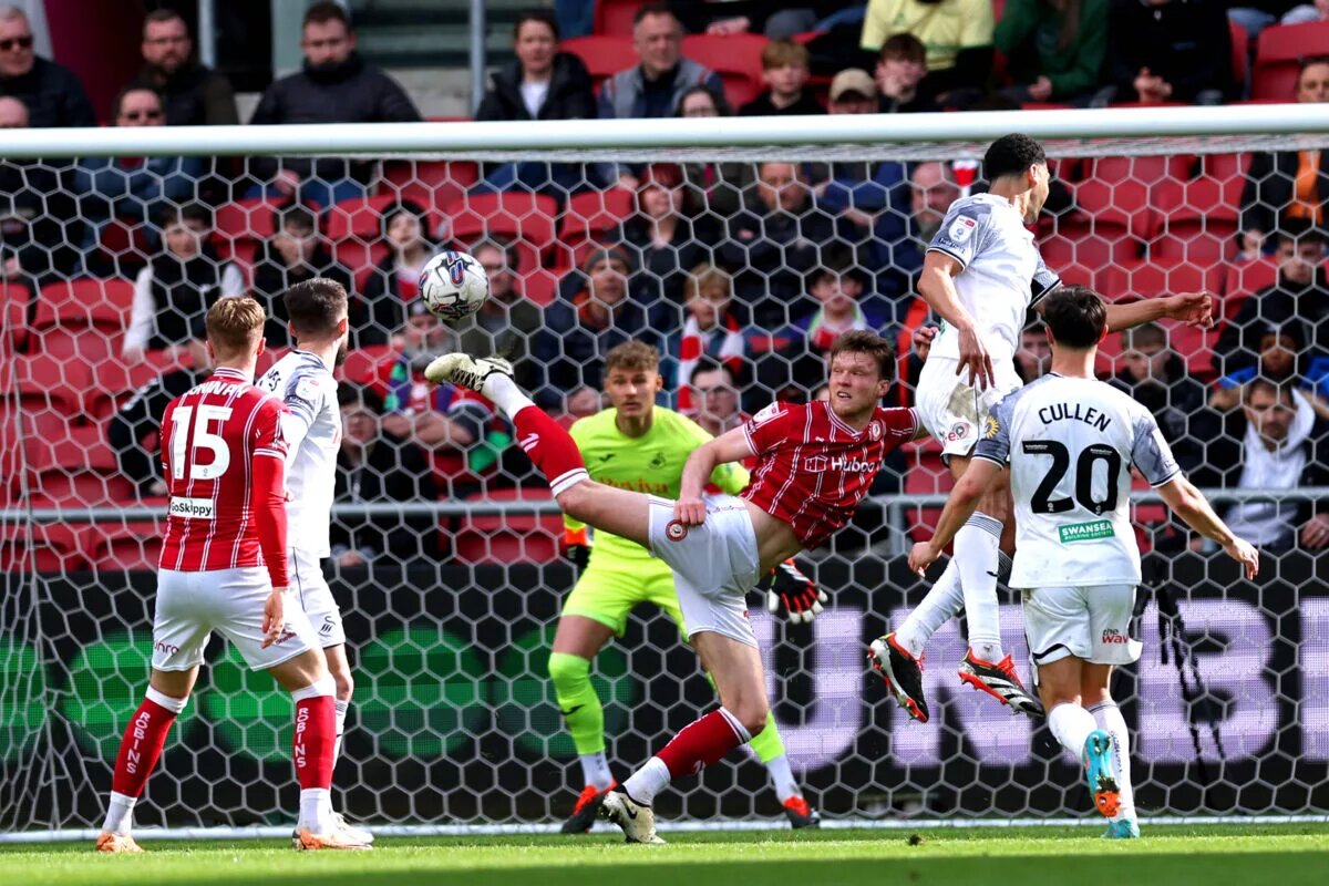 Bristol City defender stretches to block headed attempt by Swansea player